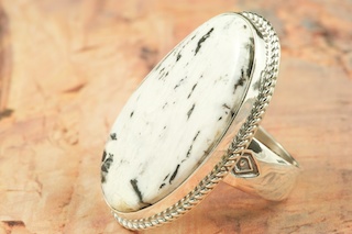 White Buffalo Turquoise set in Sterling Silver Ring. This Beautiful Stone is formed from the minerals Calcite and Iron. It is mined near Tonopah Nevada. Created by Navajo Artist Phillip Sanchez. Signed by the artist.
